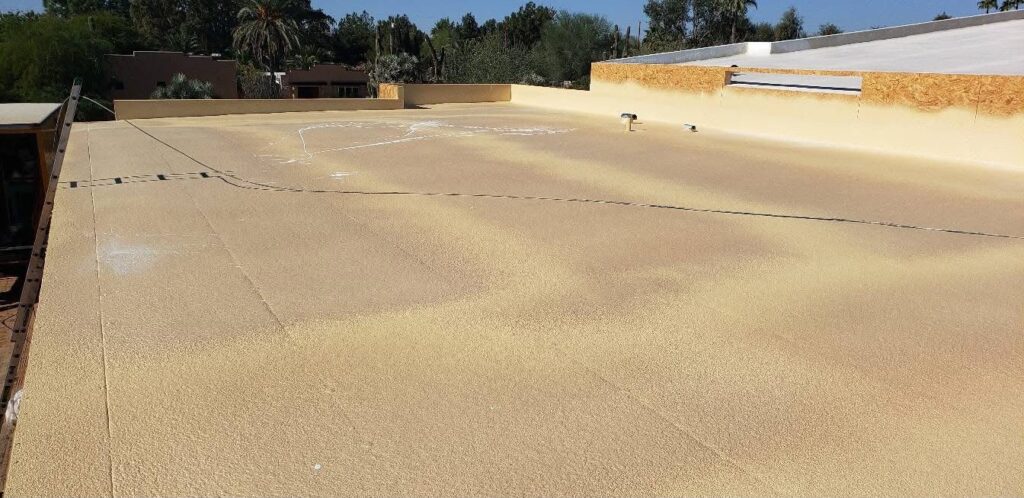 Spray polyurethane foam roofing system on a commercial roof